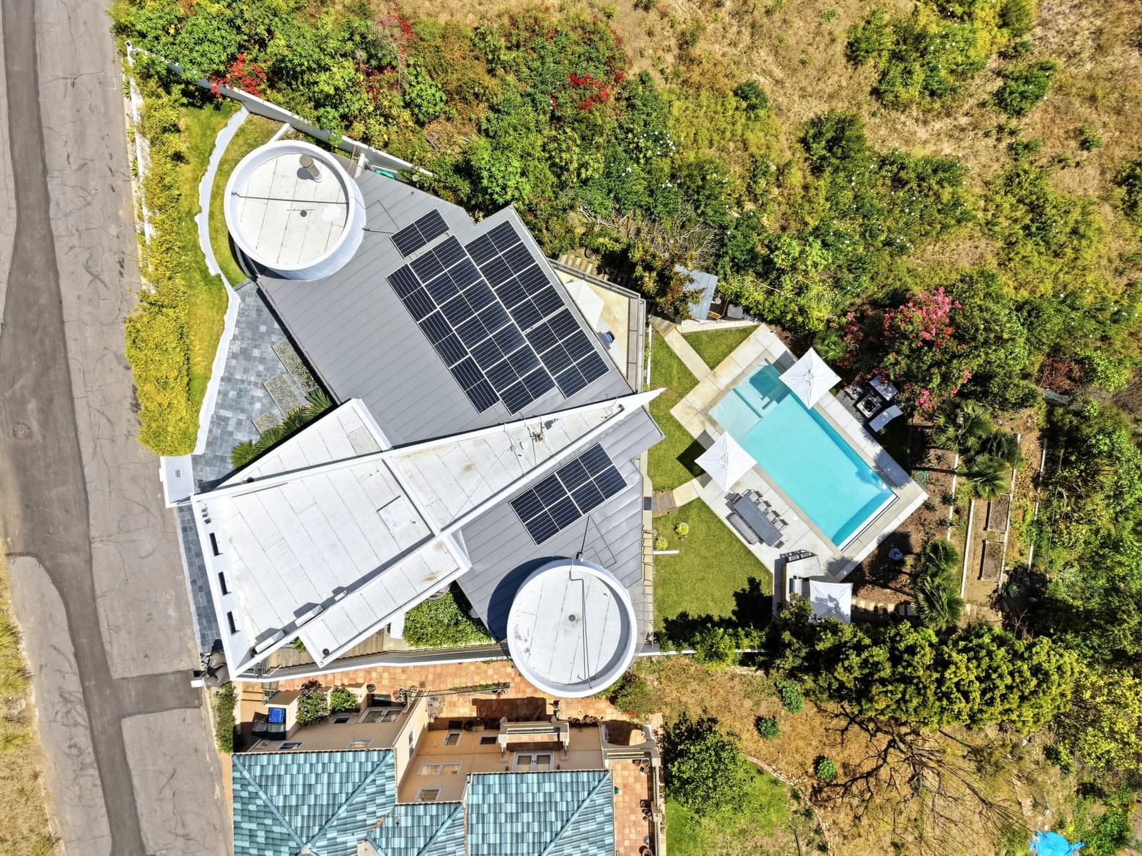 Aerial view of a modern Malibu home's geometric roofline and pool